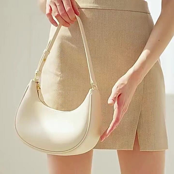 Lady crescent bag slung across one shoulder