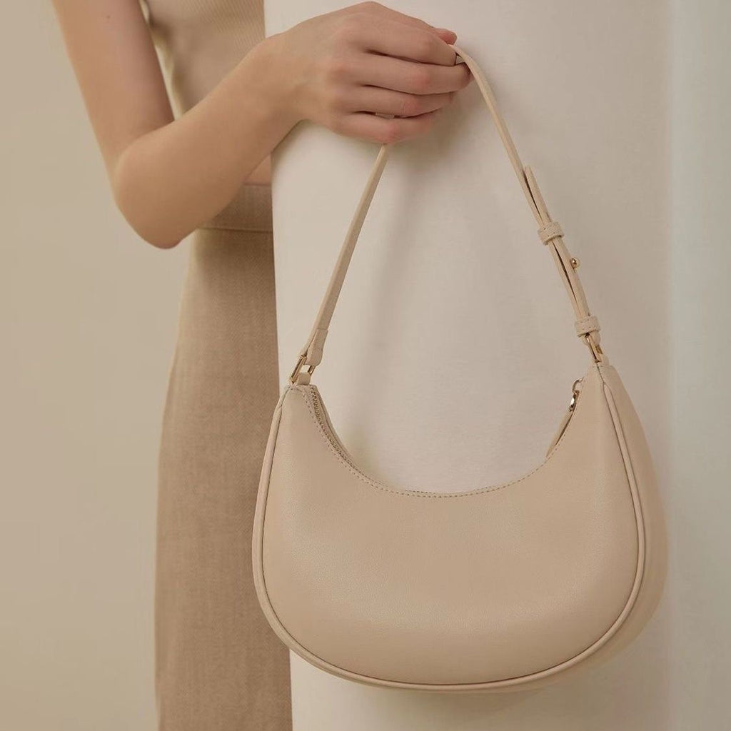 Lady crescent bag slung across one shoulder