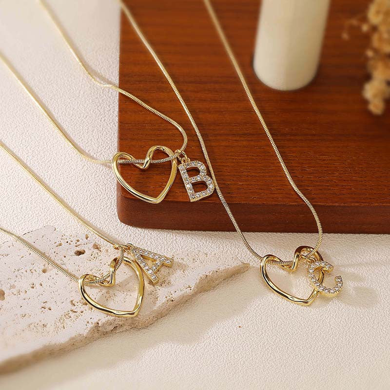 Elegant and versatile copper pendant necklace with zircon-inlaid heart and letter design